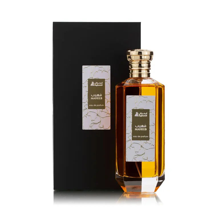 Maheeb Perfume bottle with gold cap and black box on a white background
